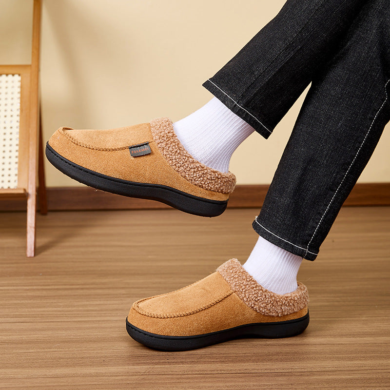 Auldweave Men’s warm wide fit winter slippers. Brown slippers worn with white socks on a wooden floor.