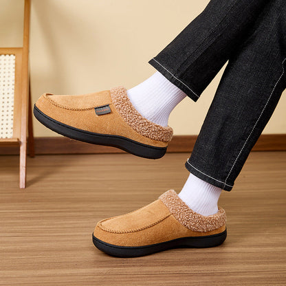 Auldweave Men’s warm wide fit winter slippers. Brown slippers worn with white socks on a wooden floor.