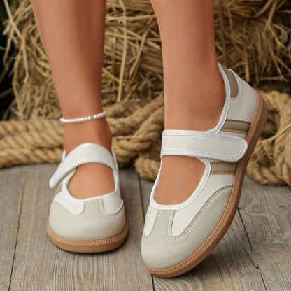 Beige women's Mary Jane trainers with white stripes, front view on feet
