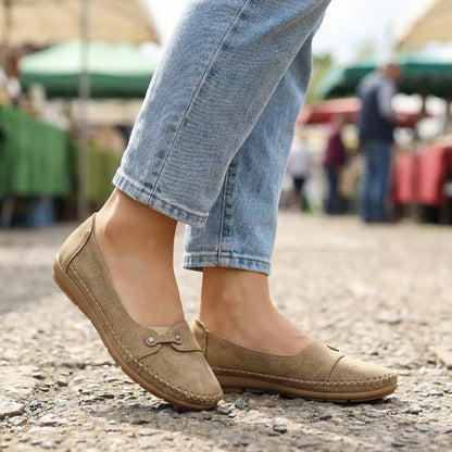 Women's khaki loafers shown on foot