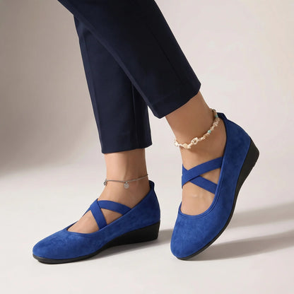Blue cross-strap wedge flats for women, on-foot studio view