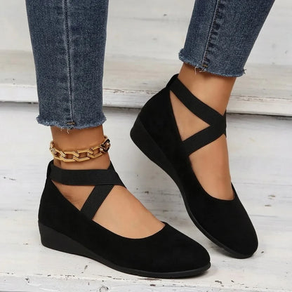 Black Mary Jane wedge flats, close on-foot view with jeans