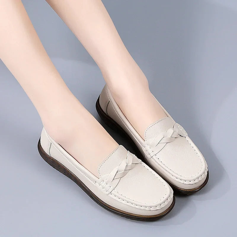 Grey bow-detail loafers for women, angled on-foot studio view