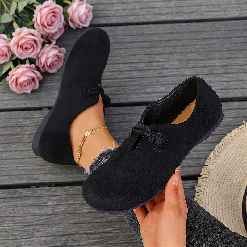 Black comfort flats with bow detail, top and side view