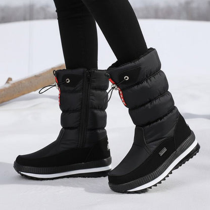 Auldweave women's waterproof mid-calf snow boots – black pair worn from the front in snow