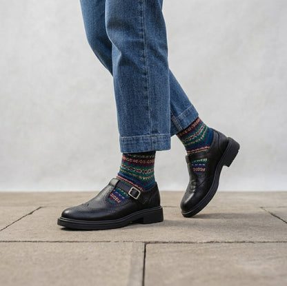 Black women's Mary Jane brogue shoes worn with patterned socks and jeans