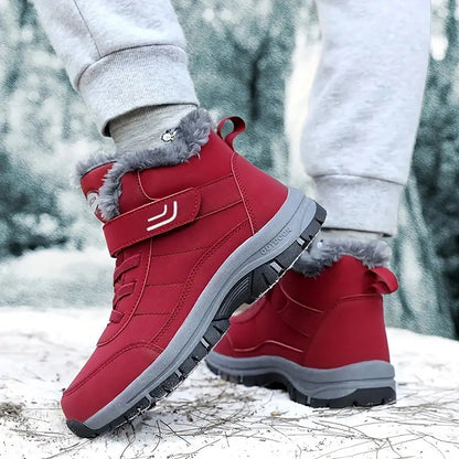 Side view of red winter boots with a grey sole