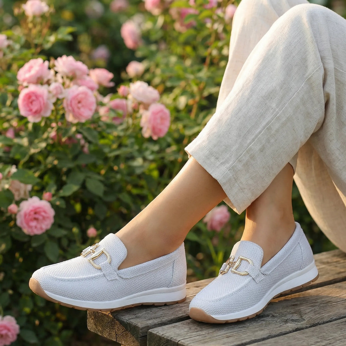 Women's white loafers shown on foot