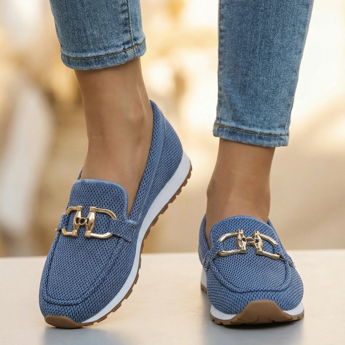 Women's blue loafers shown on foot