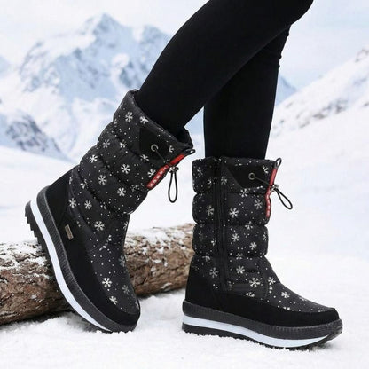 Auldweave women's waterproof mid-calf snow boots – black snowflake boots worn in a mountain setting