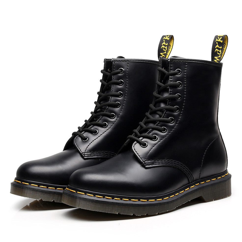 Black lace-up combat ankle boots with yellow sole stitching and heel pull tabs