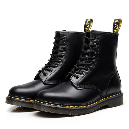 Black lace-up combat ankle boots with yellow sole stitching and heel pull tabs