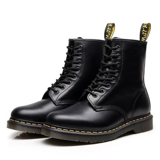 Black lace-up combat ankle boots with yellow sole stitching and heel pull tabs