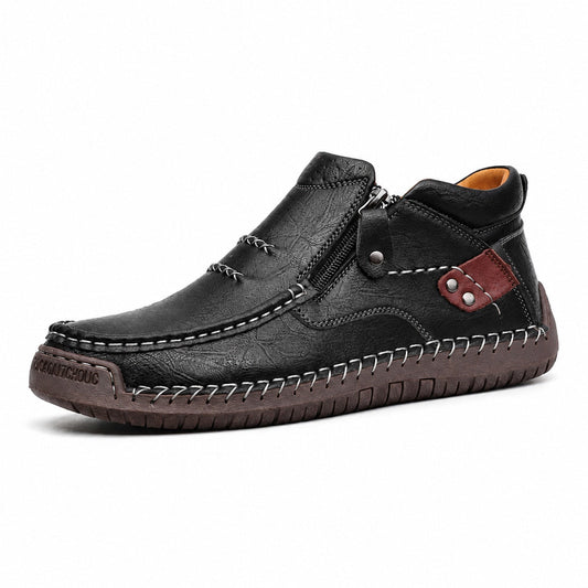 Black men's wide fit leather ankle boot with side zip and contrast stitching, side view