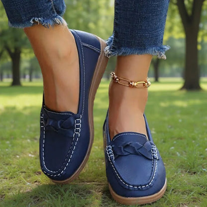 Navy loafers for women with braided vamp detail, front on-foot view