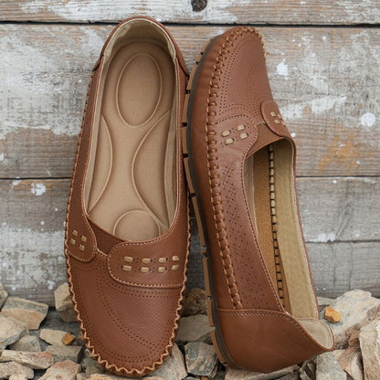 Tan women's wide fit leather loafers showing the interior and stitched side profile