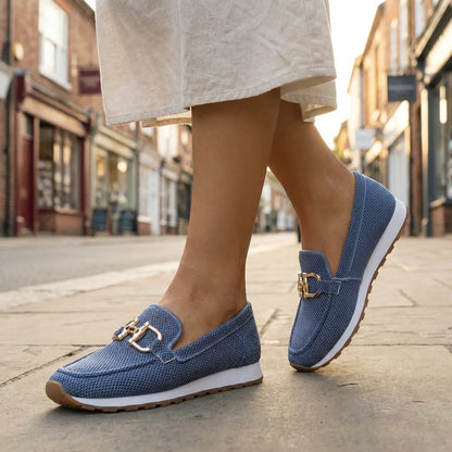 Women's blue loafers shown on foot