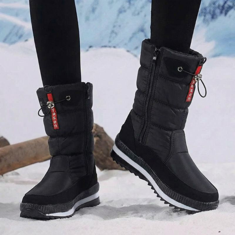 Auldweave women's waterproof mid-calf snow boots – black boots worn from the side in snow