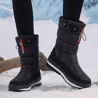 Auldweave women's waterproof mid-calf snow boots – black boots worn from the side in snow