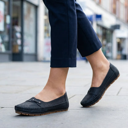 Women's black loafers shown on foot