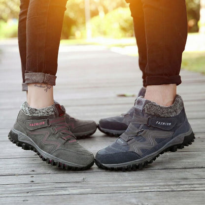 Grey and pink winter boots beside grey and blue winter boots