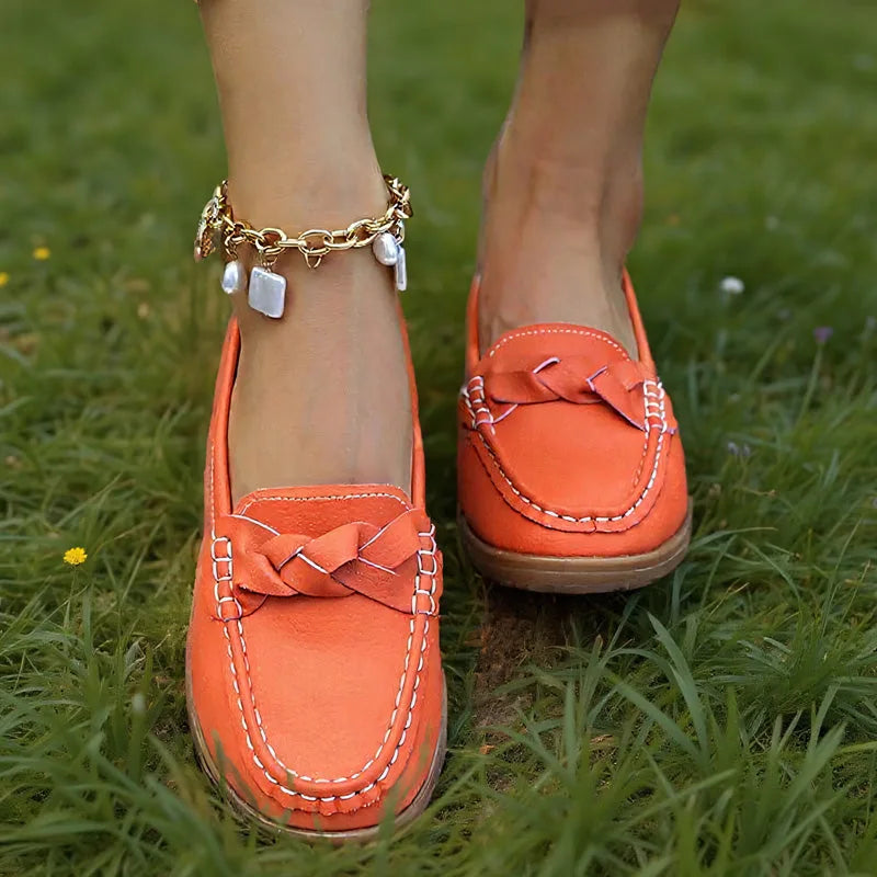 Orange loafers for women with braided vamp detail, on-foot grass view