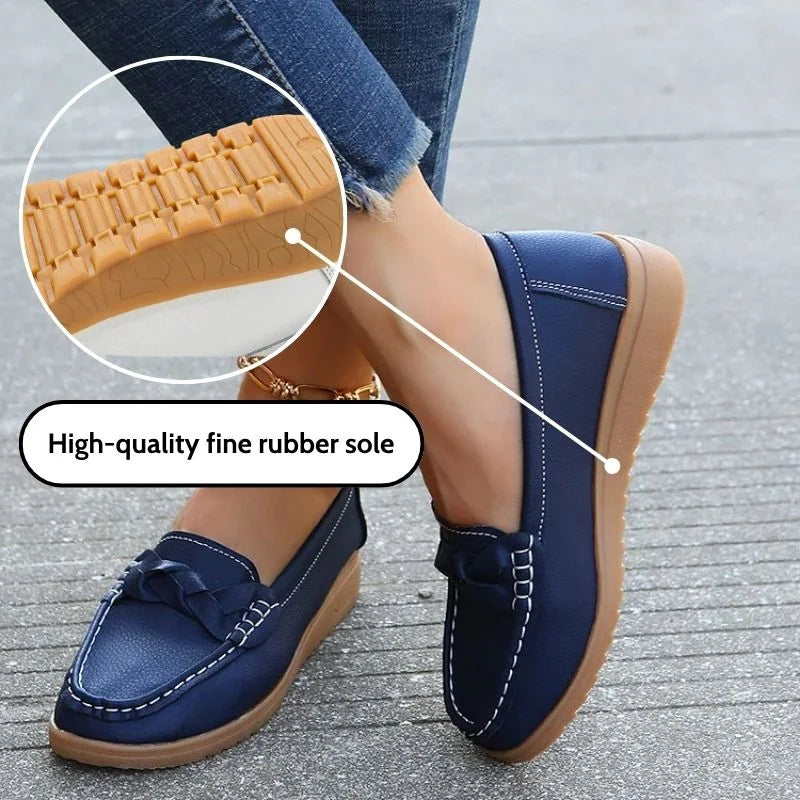 Navy women's loafer with close-up outsole and side-stitching details