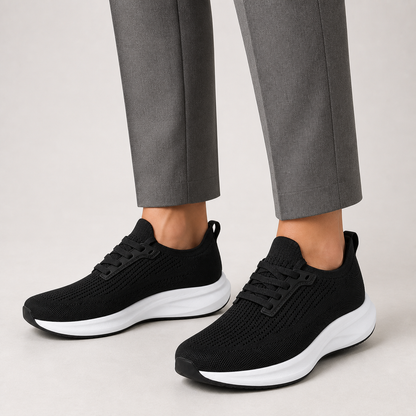Black wide toe trainers worn with grey tailored trousers