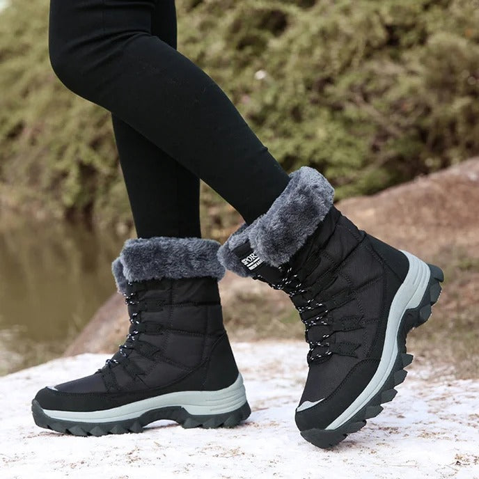 Side view of black fleece-lined winter boots worn outdoors