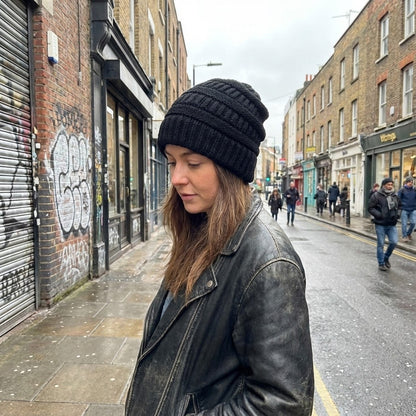 Cable-knit winter beanie – black beanie worn on a street