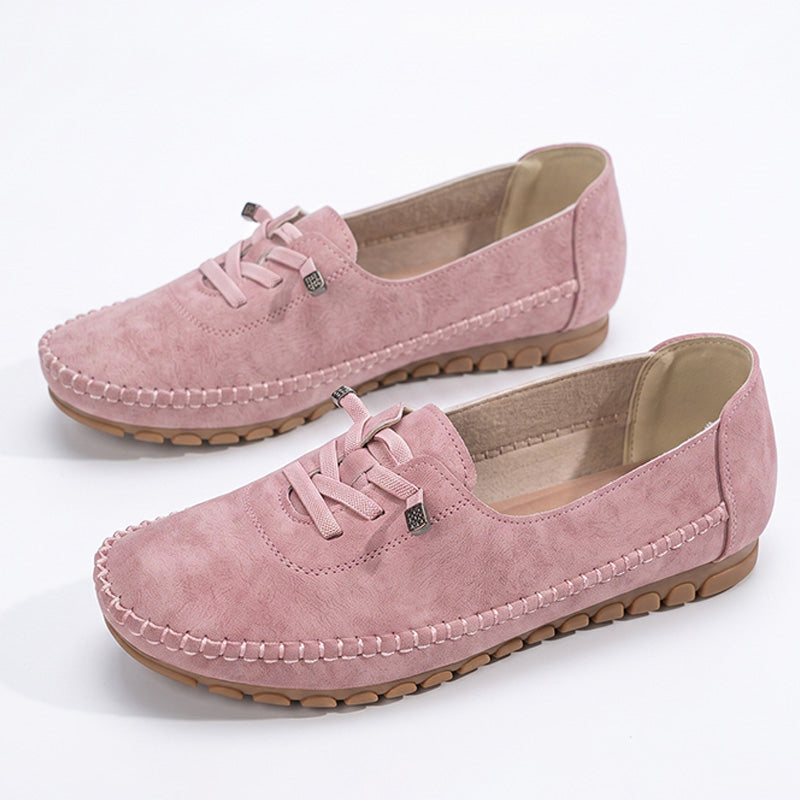Pink women's wide fit suede loafers with decorative lacing and stitched edges, product pair