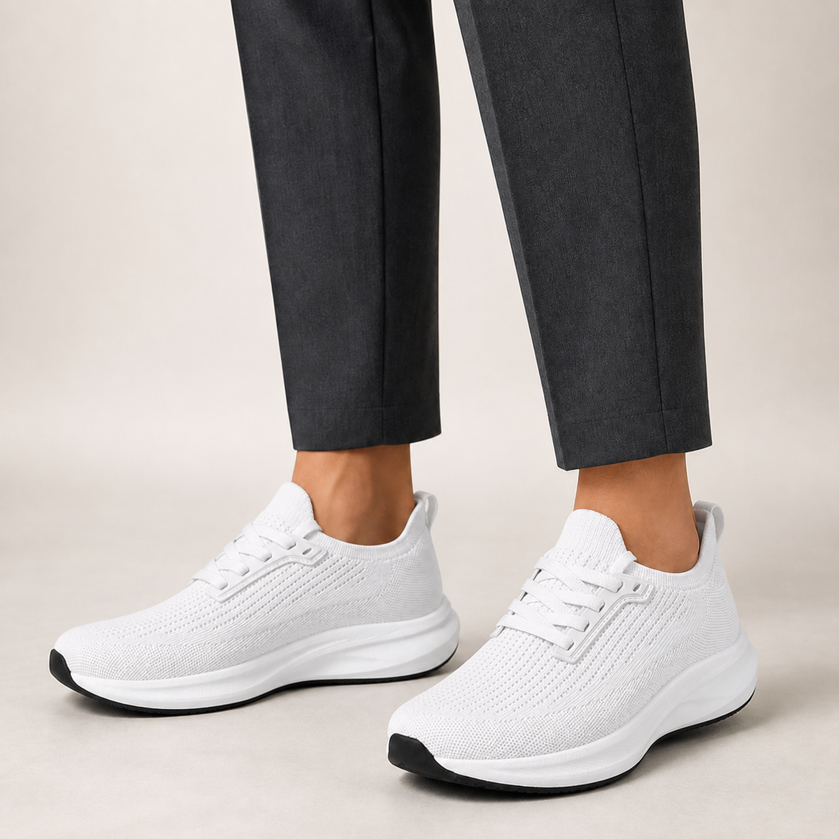 White wide toe trainers worn with charcoal tailored trousers
