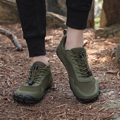 Olive green unisex wide toe box lace-up hiking shoes worn on a woodland trail