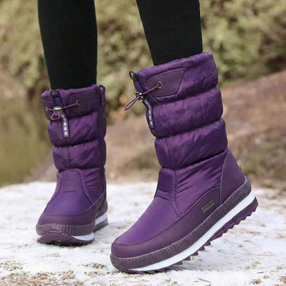 Auldweave women's waterproof mid-calf snow boots – purple pair worn from the front in snow