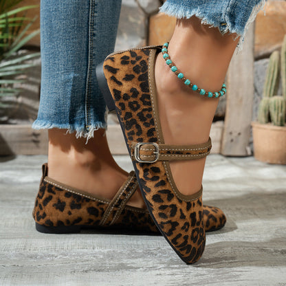 Leopard-print women's Mary Jane flats with bronze-tone buckles, worn with jeans