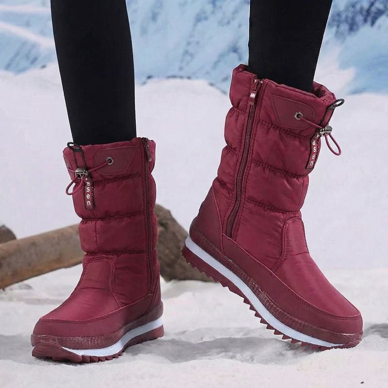 Auldweave women's waterproof mid-calf snow boots – burgundy pair worn from the front in snow