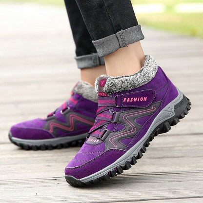 Purple winter boots showing the straps and side profile