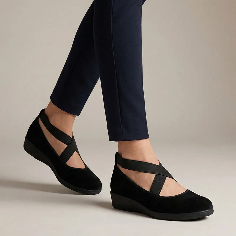 Black cross-strap flats for women, side on-foot studio view