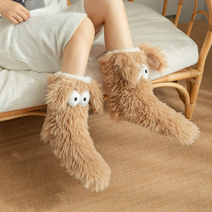 Fluffy dog slipper socks – tan pair worn on a chair