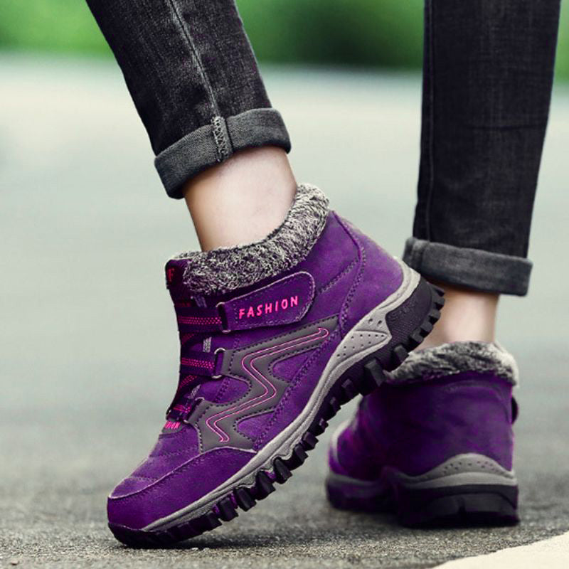 Purple winter boots with fleece collars worn outdoors
