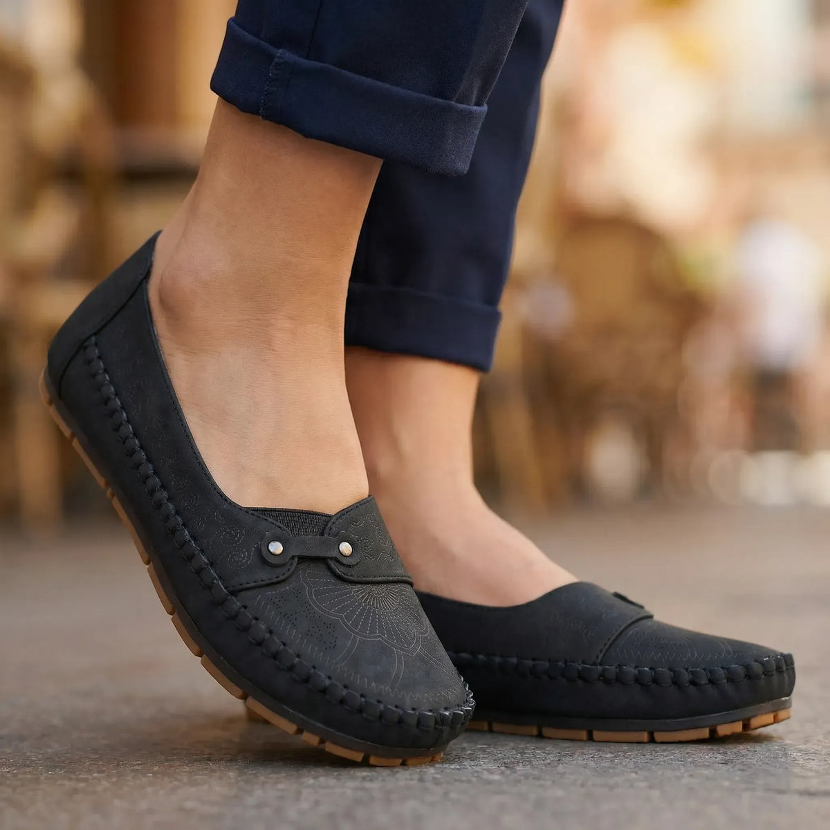 Women's black loafers shown on foot