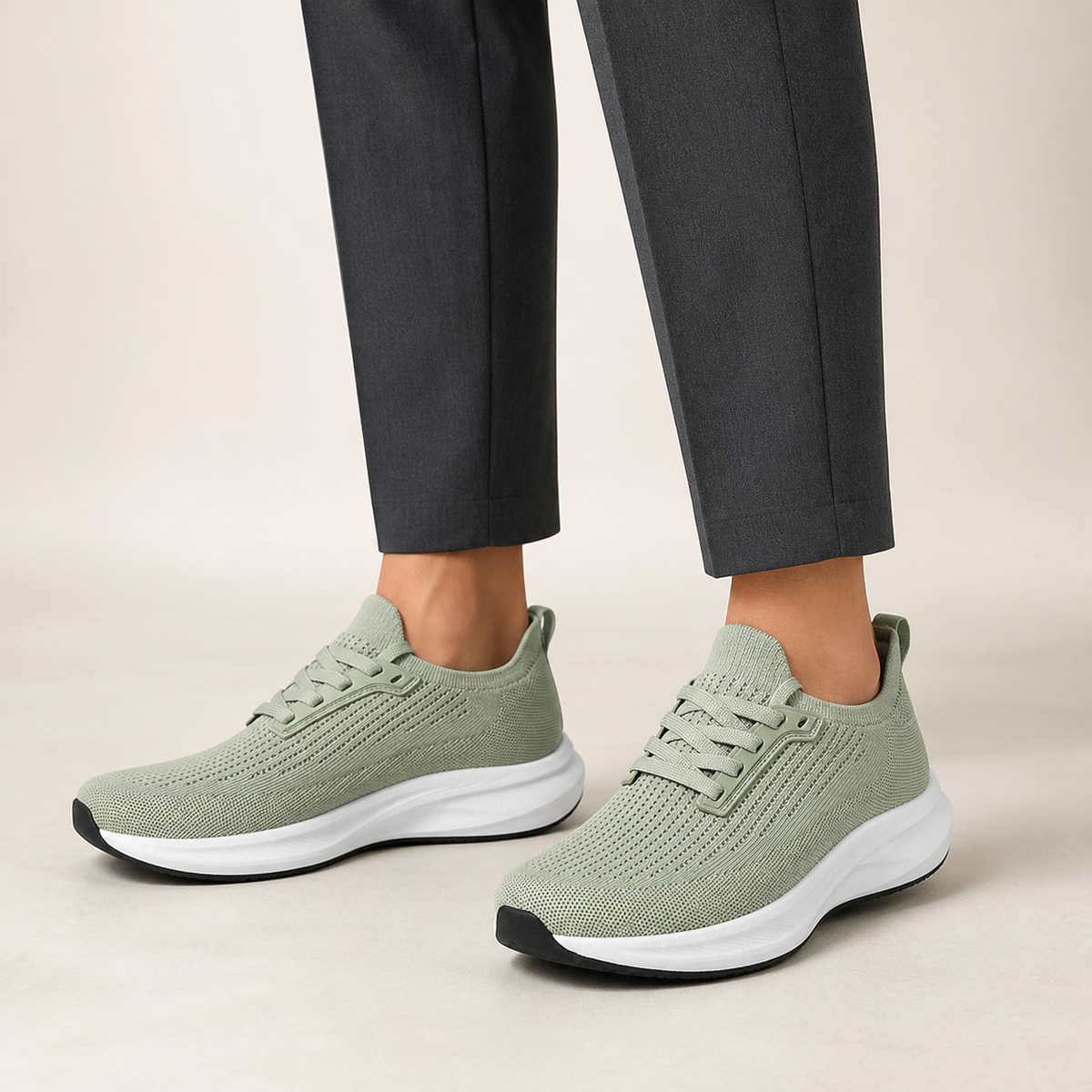 Sage green wide fit trainers worn with charcoal tailored trousers