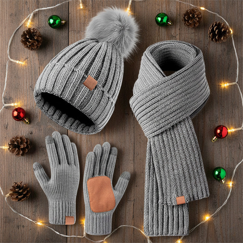 Winter hat scarf and glove set – grey set beside festive lights