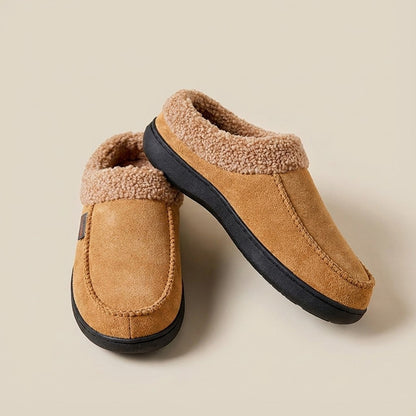 Auldweave Men’s warm wide fit winter slippers. Pair of tan slippers with fleece lining on a beige background