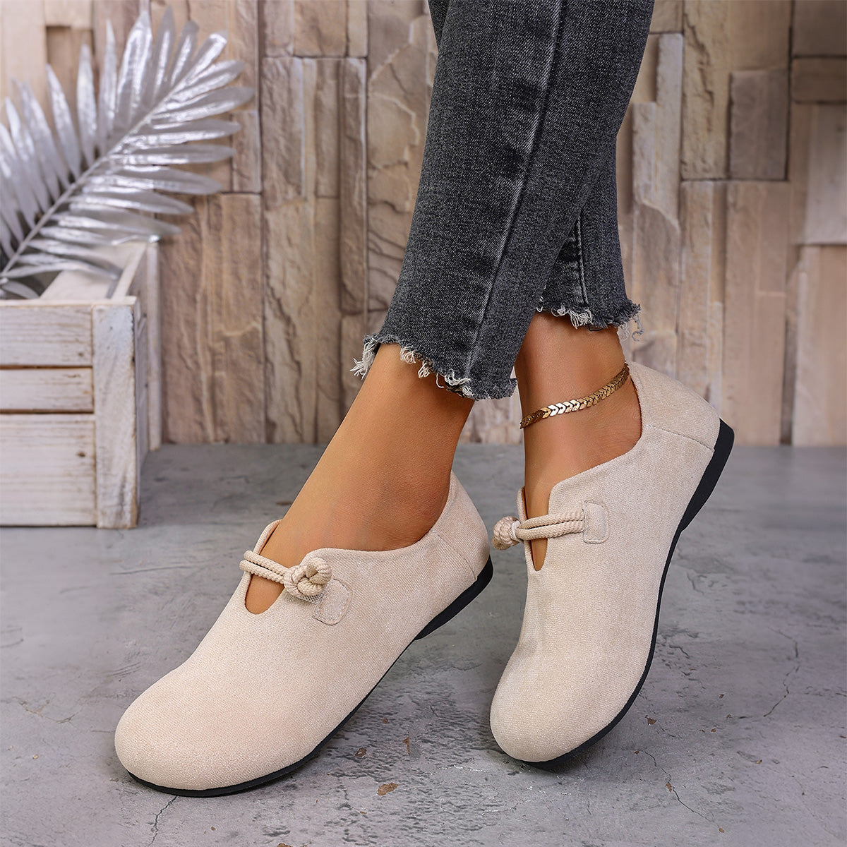 Cream women's wide fit suede loafers with decorative buckles, worn with cropped jeans