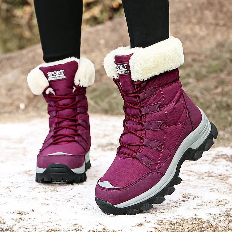 Red lace-up winter boots with cream fleece cuffs worn outdoors