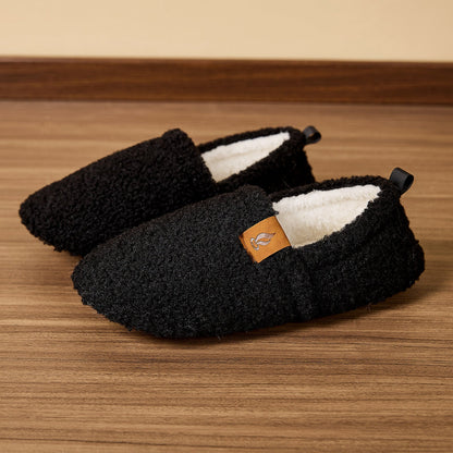 Auldweave women's warm shearling slippers – black pair on a wooden floor