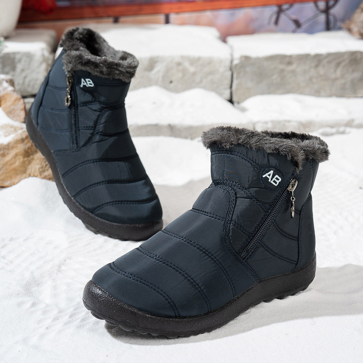 Side view of navy blue winter boots showing the zipper