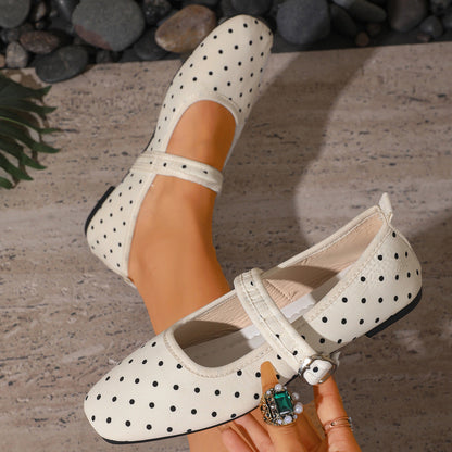 Cream polka-dot women's Mary Jane flats showing the buckle strap and lining