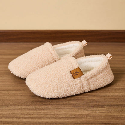 Auldweave women's warm shearling slippers – cream pair on a wooden floor